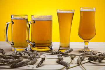 Beer glass with yellow background