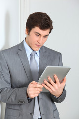 Businessman standing with electronic pad
