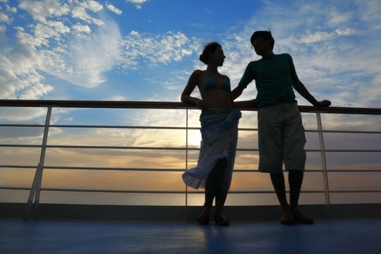 man and woman on deck of cruise ship.