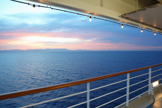 View From Deck Of Cruise Ship. Sunset. Row Of Lamps.