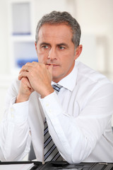 Fototapeta premium Portrait of businessman sitting at his desk