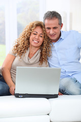 Couple surfing on internet at home