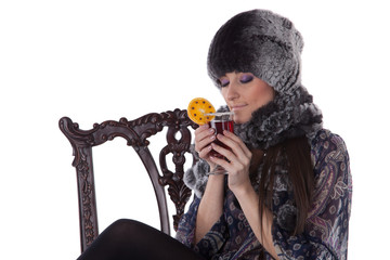 Fototapeta na wymiar Young woman in fur with glass of mulled wine.