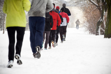 Naklejka premium People running in winter park