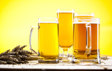 Beer glass with yellow background