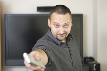 man holding  television  remote controller