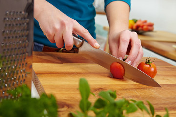 Slicing tomatoes on carving board