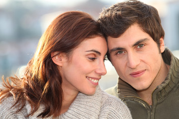 Portrait of young smiling couple in town