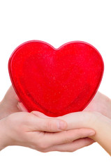 Fototapeta premium woman and man hands carefully holding red heart