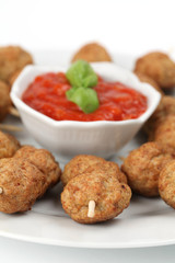 Roast meatballs with tomato sauce. Shallow DOF