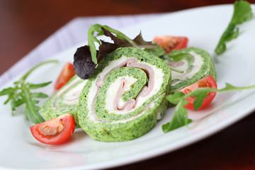 Spinach roll with garlic cheese and ham. Shallow dof