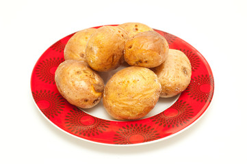 baked potatoes on a plate isolated on white