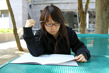 Chinese girl reading book in a University