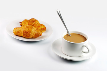 white coffee mug and croissants on plate