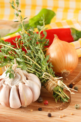 garlic, onion and thyme on a yellow napkin