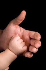 the hands of father and child