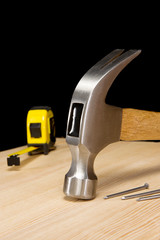 hammer, tape measure and nail