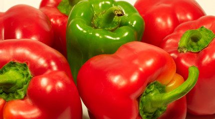 Red and green fresh sweet peppers close up