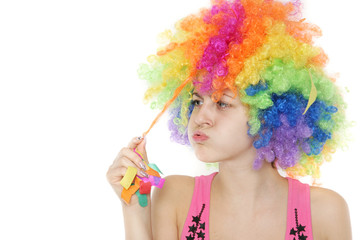 young woman in colorful clownish wig over white