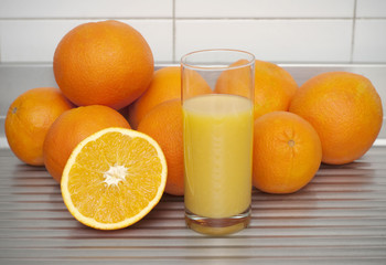 Oranges with a cup of juice juice