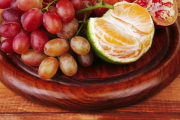 Naklejka na ściany i meble fruits on wooden plate