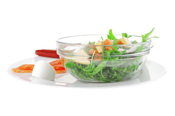 salad with salmon in transparent bowl