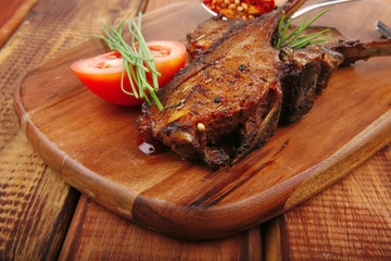meat on wooden plate : roast ribs on wood
