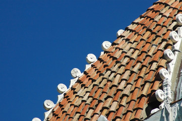 Roof of the Baptistery of Pisa Cathedral. Blue sky background.