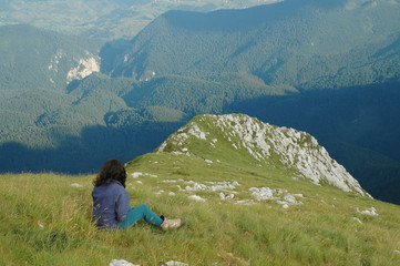 Naklejka na ściany i meble Girl resting in Piatra Craiului mountains, Romania