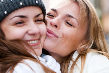 Two cheerful girls twins, in the street