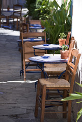 Chairs and tables outside a small restaurant-café  in an alley