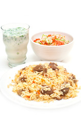 Caucasian traditional pilaf, ayran and salad. Rice with meat
