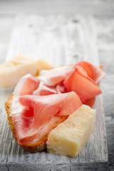 slice bread with parma ham and grana -pane prosciutto grana
