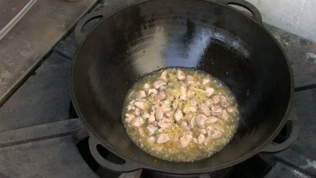 Stirring pieces of meat and Frying onion in Wok