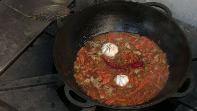 Adding chili and garlic to Pilaf ingredients in Wok, Closeup