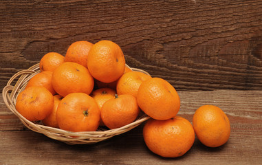 ripe tangerine fruits in basket