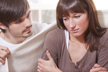man and ill woman at home