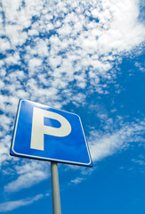 Parking signal against a blue sky