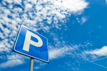 Parking sign against a blue sky
