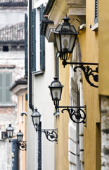 Fototapeta na wymiar Pięć latarnie wzdłuż ulicy w mieście Brescia