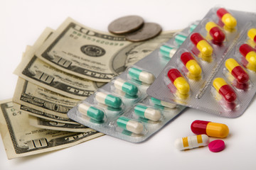 tablets in packs  against dollar banknotes