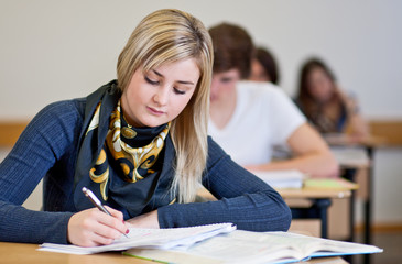 Student working on homework in classroom