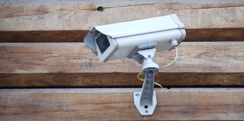 video camera on a wooden wall