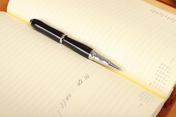 Personal organizer and pen on the table