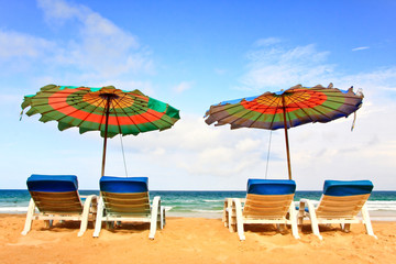 chairs on beach with blue sky