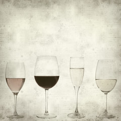 textured old paper background with four different wines in glass