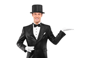 Magician wearing top hat with raised left hand