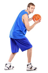 Full length portrait of a basketball player posing with a ball