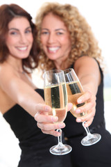 Girlfriends cheering with glasses of champagne