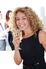 Blond smiling woman holding glass of champagne